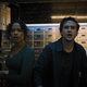Zoey Davis (Taylor Russell) and Ben Miller (Logan Miller) look shocked while standing in a safety deposit box room in Escape Room: Tournament of Champions.